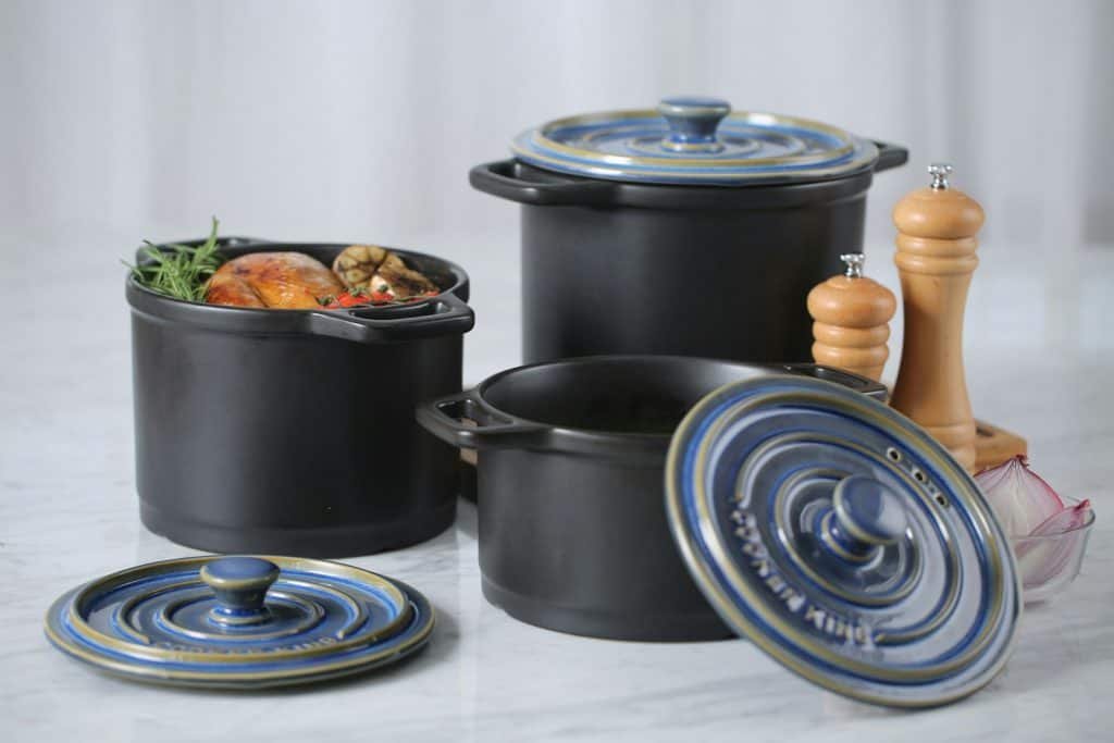 Set of three dutch ovens on a kitchen counter for display